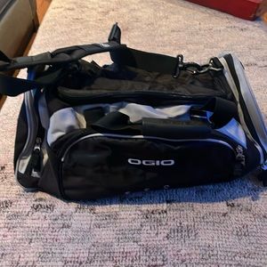 New OGIO sports illustrated black and gray duffle bag with shoulder strap.